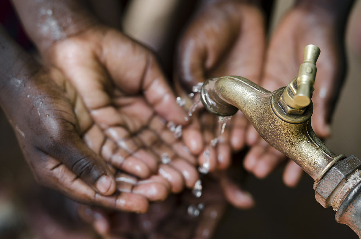 hands catch water in off grid community